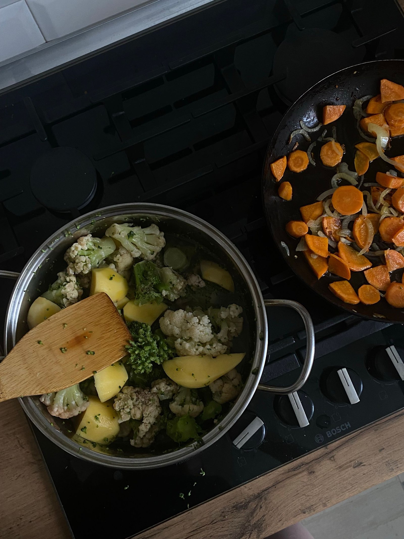 Cooking vegetables in a pot and pan